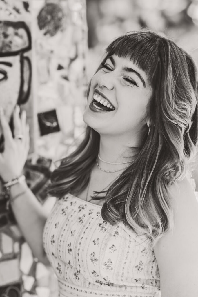 Black and white close-up senior portrait of Lyla laughing.