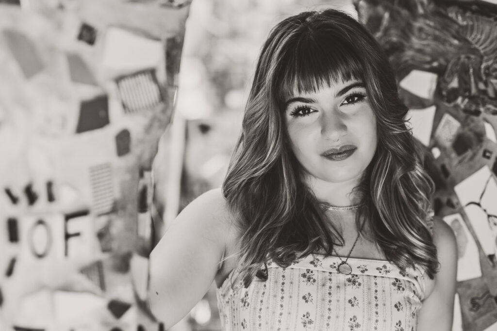Black and white close-up portrait of Lyla looking directly at the camera with a calm expression.