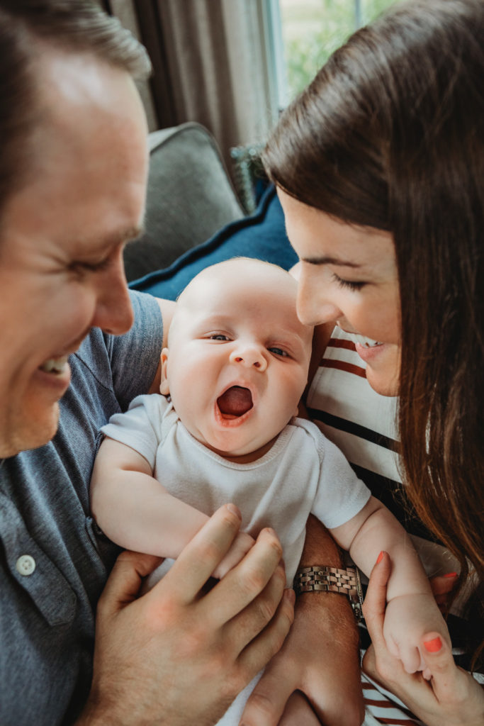 Parents laughing at 3 month old baby

