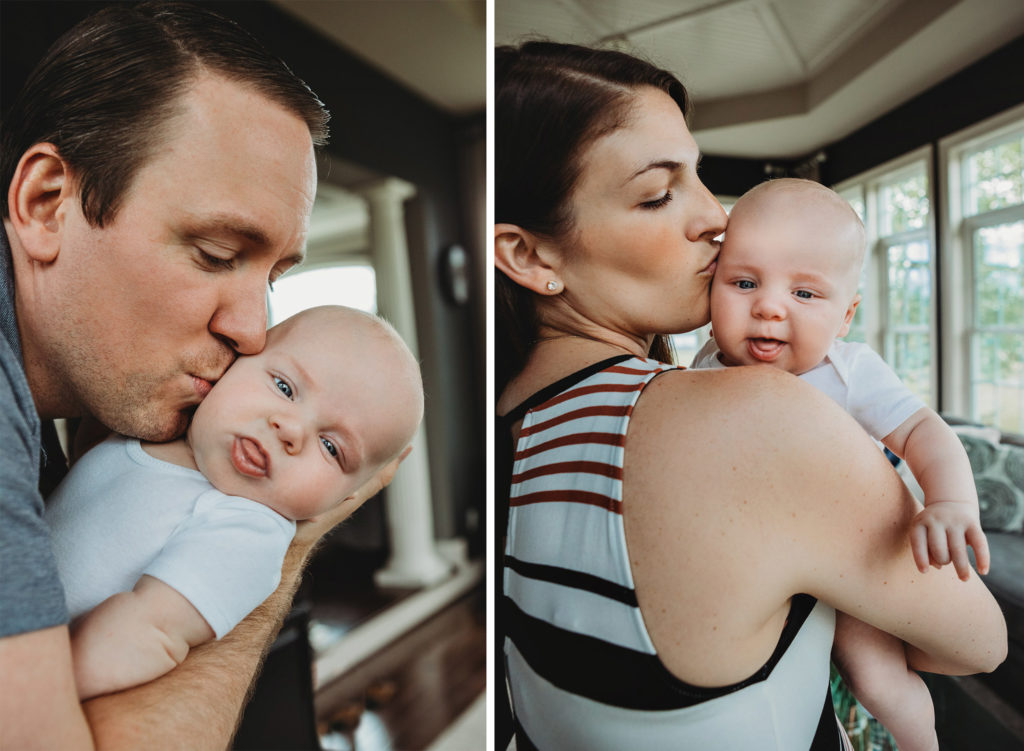 Parents kissing 3 month old baby.