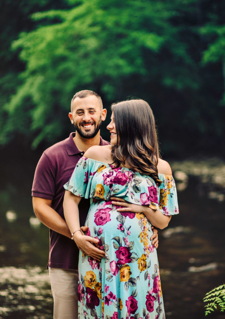 Maternity photo session with couple laughing near the Wissahickon creek in Philadelphia