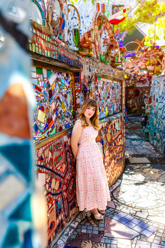 High school senior portrait of Lyla in a colorful South Street setting